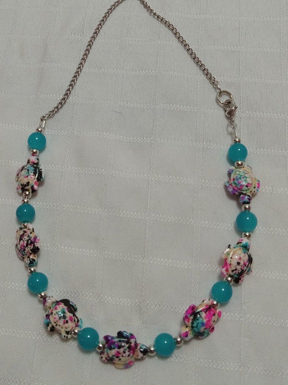 Pretty handmade necklace with little turtles and glass bead